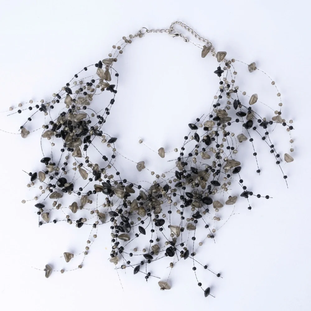is a multi-strand beaded statement necklace featuring black and‎ grey B4
